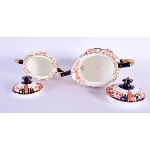 702 - A ROYAL CROWN DERBY IMARI TEASET ON TRAY. Largest 36 cm x 20 cm. (8)