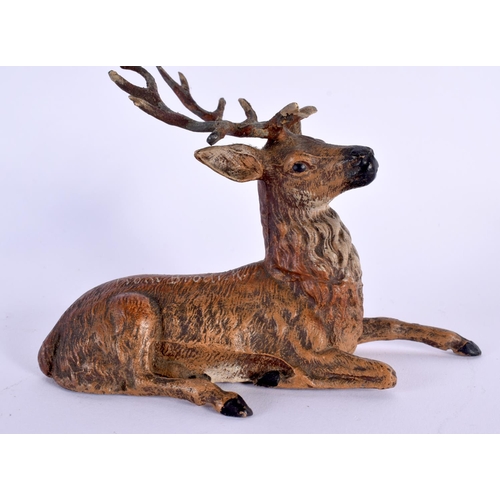 703 - AN ANTIQUE AUSTRIAN COLD PAINTED SPELTER DEER and a medallion. Largest 15 cm diameter. (2)