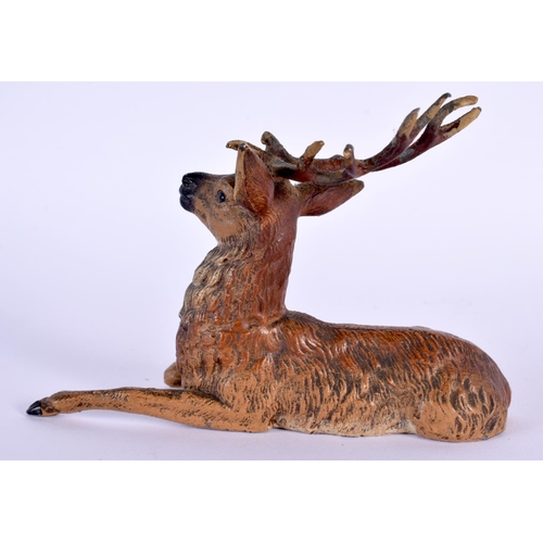 703 - AN ANTIQUE AUSTRIAN COLD PAINTED SPELTER DEER and a medallion. Largest 15 cm diameter. (2)