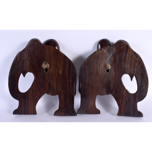 714 - A PAIR OF ANTIQUE INDIAN CARVED HARDOWOD ELEPHANT WALL PLAQUES with bone feet. 21 cm x 18 cm.