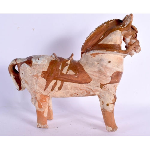 75 - A CONTINENTAL FOLK ART PRIMITIVE POTTERY FIGURE OF A HORSE. 24 cm x 22 cm.