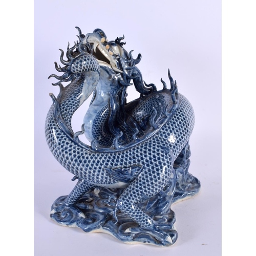 752 - A RARE 17TH/18TH CENTURY CHINESE JAPANESE BLUE AND WHITE PORCELAIN DRAGON modelled upon a scrolling ... 