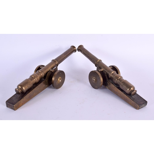 761 - A PAIR OF ANTIQUE GENTLEMANS BRONZE AND CARVED WOOD DESK CANNONS. 24 cm long.