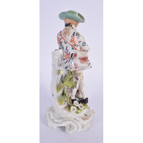 769 - AN 18TH CENTURY DERBY FIGURE OF A PIPE PLAYER modelled beside a calf. 19 cm high.