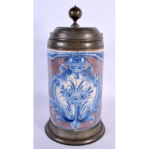 783 - A LARGE 18TH CENTURY GERMAN MANGANESE GROUND FAIENCE STEIN painted with an armorial type panel. 27 c... 