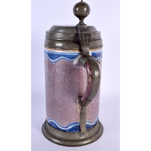 783 - A LARGE 18TH CENTURY GERMAN MANGANESE GROUND FAIENCE STEIN painted with an armorial type panel. 27 c... 