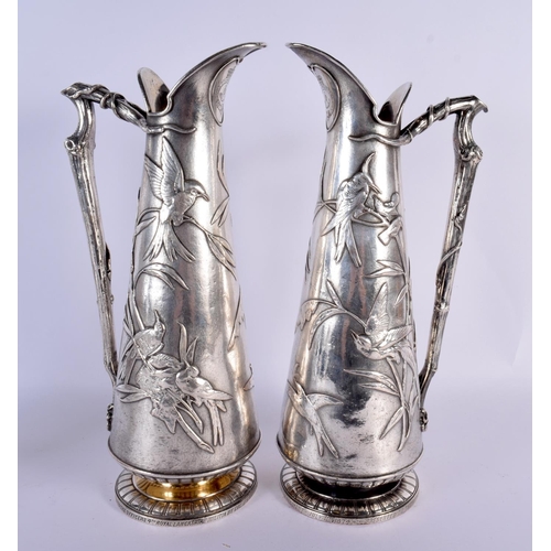 792 - A RARE LARGE PAIR OF ELKINGTONS AESTHETIC MOVEMENT SILVER PLATED JUGS decorated all over with birds ... 