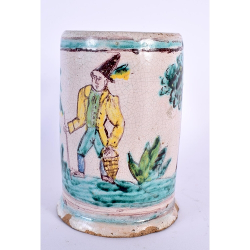 799 - AN 18TH/19TH CENTURY EUROPEAN FAIENCE POTTERY MUG painted with a roaming male. 11 cm high.