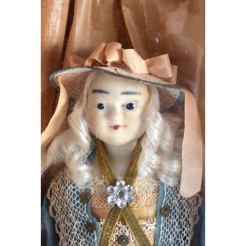 830 - A MID 19TH CENTURY EUROPEAN WAX HEADED GLASS CASED DOLL. 53 cm x 22 cm.