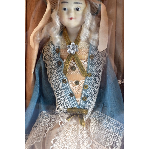 830 - A MID 19TH CENTURY EUROPEAN WAX HEADED GLASS CASED DOLL. 53 cm x 22 cm.