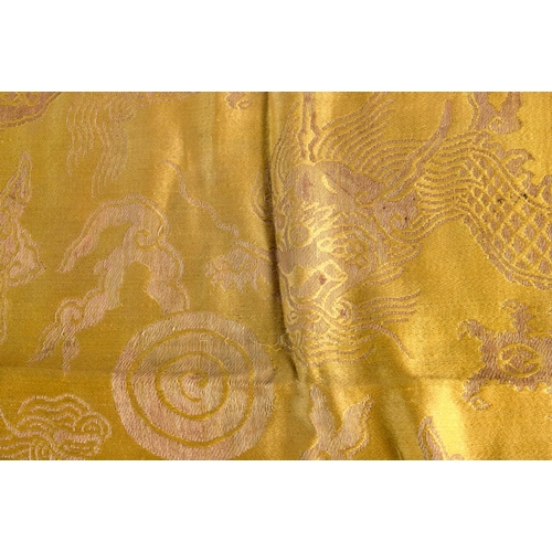 2179 - A 19TH CENTURY CHINESE YELLOW EMBROIDERED SILK COVER Qing. 105 cm square. Note: Sold with paper note... 