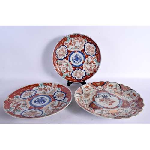 2432 - THREE 19TH CENTURY JAPANESE MEIJI PERIOD IMARI PLATES painted with landscapes. 30 cm wide. (3)