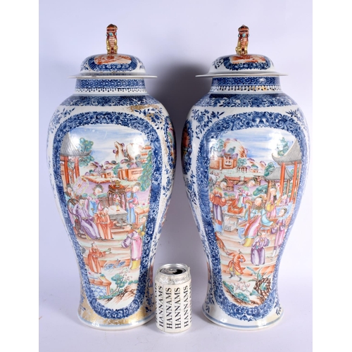 2460 - A VERY LARGE PAIR OF 18TH CENTURY CHINESE EXPORT BLUE AND WHITE VASES AND COVERS Qianlong, painted w... 