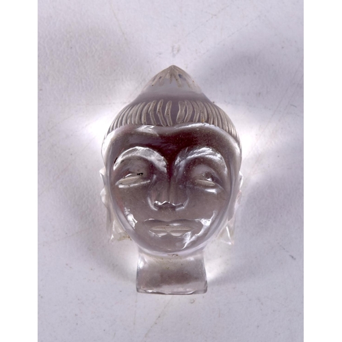 3588 - A small carved Crystal Buddhas head 3 pm.