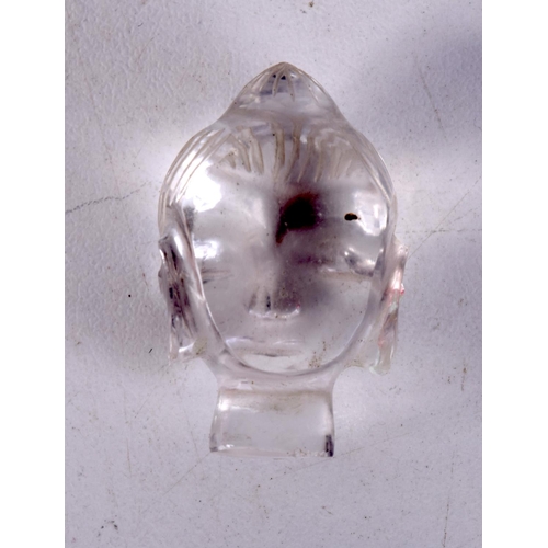 3588 - A small carved Crystal Buddhas head 3 pm.