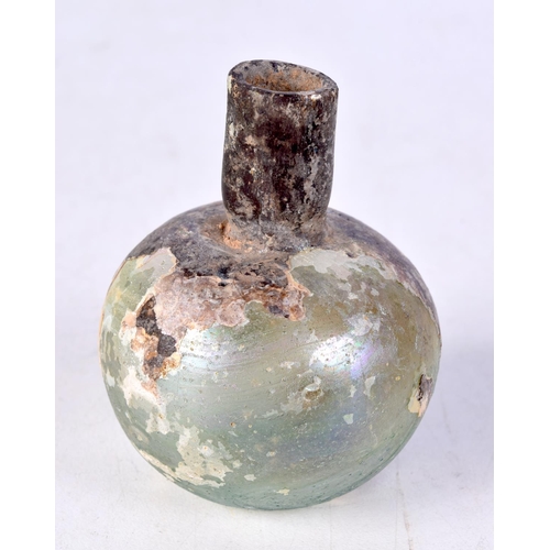 3594 - A small early glass bottle probably Roman 7 cm.