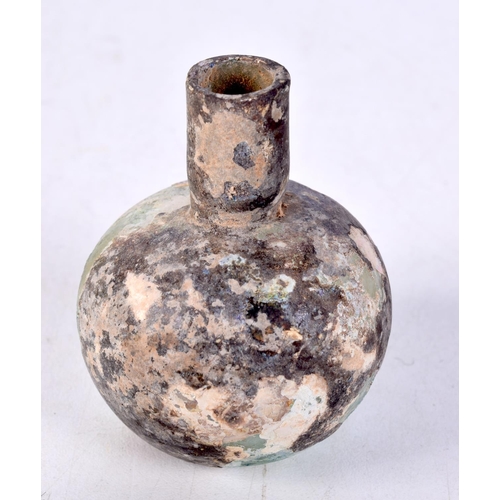 3594 - A small early glass bottle probably Roman 7 cm.