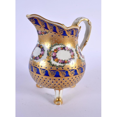 186 - Late 18th c. Sevres three footed milk jug enamelled and gilt with floral wreaths within cobalt blu... 