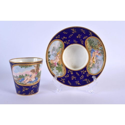 187 - Sevres trembleuse cup and saucer painted with three panels of figures on a cobalt blue and gilt grou... 