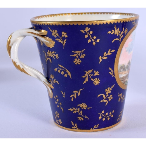 187 - Sevres trembleuse cup and saucer painted with three panels of figures on a cobalt blue and gilt grou... 