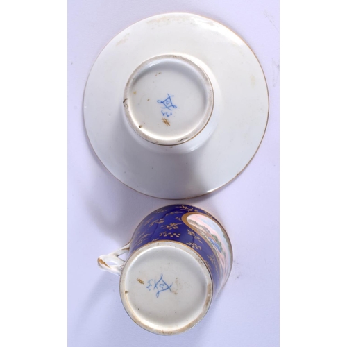 187 - Sevres trembleuse cup and saucer painted with three panels of figures on a cobalt blue and gilt grou... 
