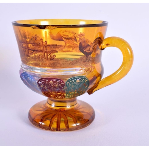 19 - AN UNUSUAL 19TH CENTURY BOHEMIAN AMBER GLASS CUP painted with fowl and motifs. 10 cm x 8 cm.