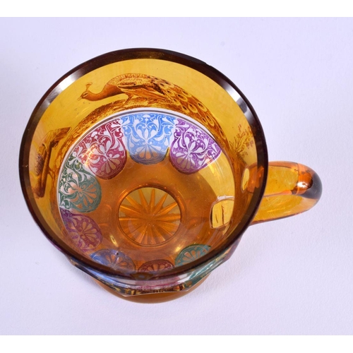 19 - AN UNUSUAL 19TH CENTURY BOHEMIAN AMBER GLASS CUP painted with fowl and motifs. 10 cm x 8 cm.