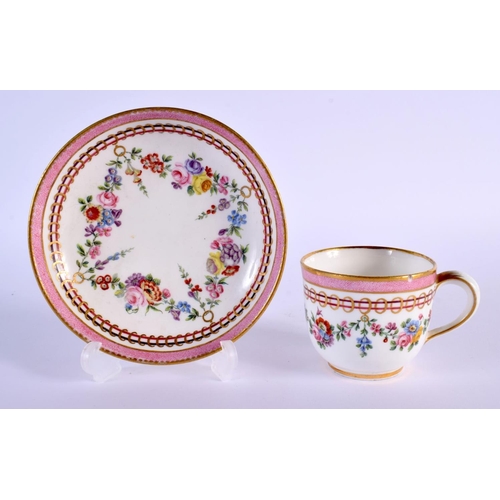 202 - Sevres coffee cup and saucer painted with festoons of flowers hanging from gilt rings under a pink b... 
