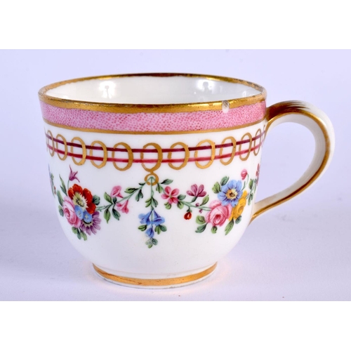 202 - Sevres coffee cup and saucer painted with festoons of flowers hanging from gilt rings under a pink b... 
