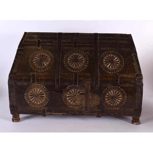 405 - A 19TH CENTURY WESTERN INDIAN CARVED WOOD DOWRY BOX with pitched top and hinged lid, decorated with ... 