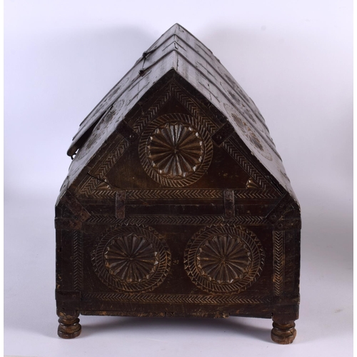 405 - A 19TH CENTURY WESTERN INDIAN CARVED WOOD DOWRY BOX with pitched top and hinged lid, decorated with ... 