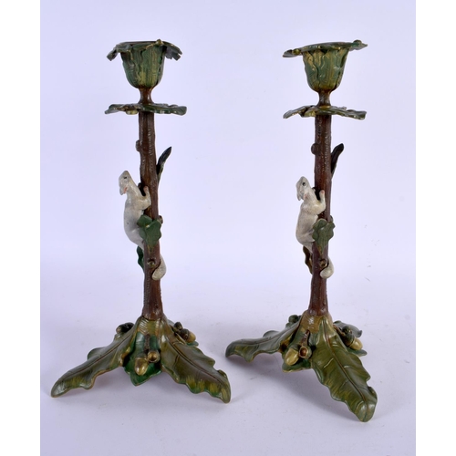 409 - A PAIR OF CONTINENTAL COLD PAINTED BRONZE CANDLESTICKS formed with squirrels climbing on a tree. 29 ... 