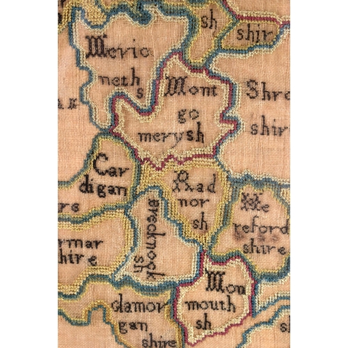 435 - AN 18TH CENTURY FRAMED SAMPLER MAP OF ENGLAND AND WALES by Ann Ambler 1785. 60 cm x 54 cm.