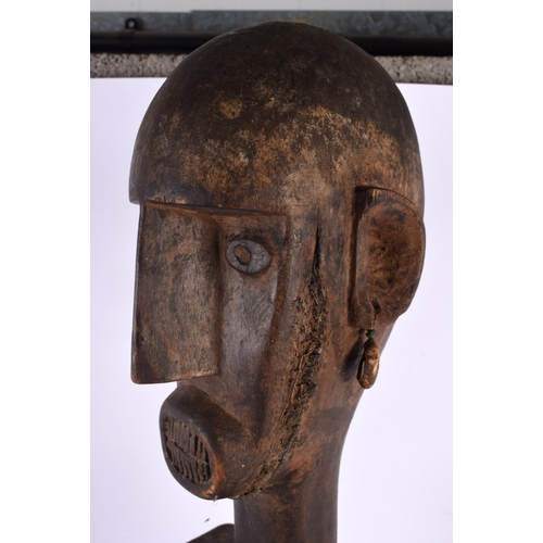 441 - A LARGE EARLY 20TH CENTURY AFRICAN TRIBAL CARVED WOOD PULLEY. 70 cm high.