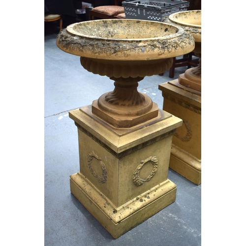 442 - A GOOD PAIR OF 19TH CENTURY EUROPEAN TERRACOTTA URNS ON STANDS of classical form. 80 cm x 36 cm.