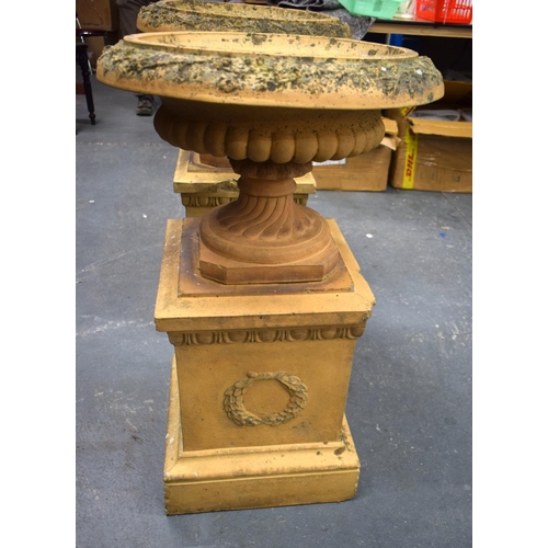 442 - A GOOD PAIR OF 19TH CENTURY EUROPEAN TERRACOTTA URNS ON STANDS of classical form. 80 cm x 36 cm.