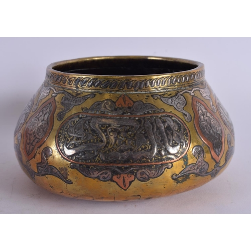 458 - A 19TH CENTURY MIDDLE EASTERN ISLAMIC SILVER INLAID CENSER decorated with calligraphy. 15 cm wide.