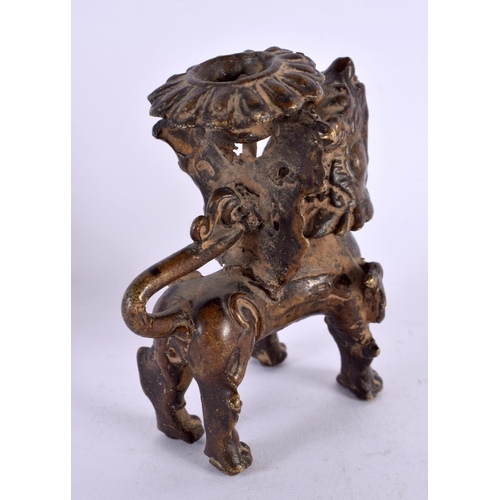 459 - A 17TH/18TH CENTURY SOUTH EAST ASIAN BRONZE CANDLESTICK formed as a scowling beast. 9 cm x 6 cm.