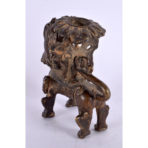 459 - A 17TH/18TH CENTURY SOUTH EAST ASIAN BRONZE CANDLESTICK formed as a scowling beast. 9 cm x 6 cm.