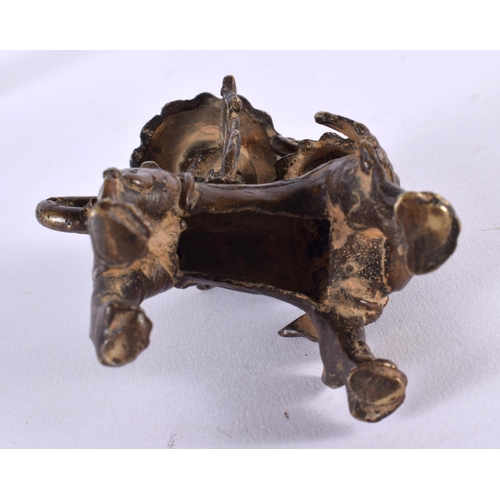 459 - A 17TH/18TH CENTURY SOUTH EAST ASIAN BRONZE CANDLESTICK formed as a scowling beast. 9 cm x 6 cm.