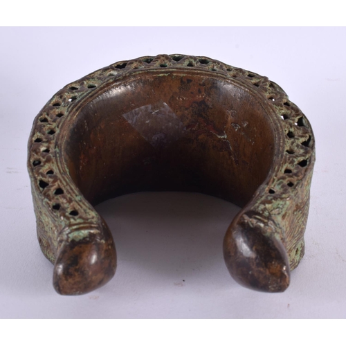 461 - A LARGE 18TH/19TH CENTURY MIDDLE EASTERN BRONZE CUFF BANGLE. 13 cm x 13 cm.