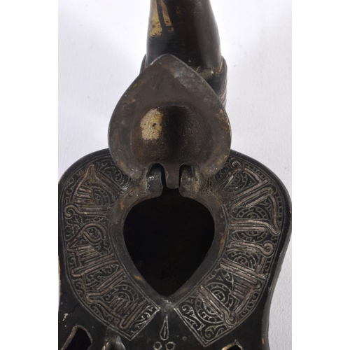 462 - A 19TH CENTURY MIDDLE EASTERN SILVER INLAID BRONZE OIL LAMP formed as a bird, decorated with motifs.... 