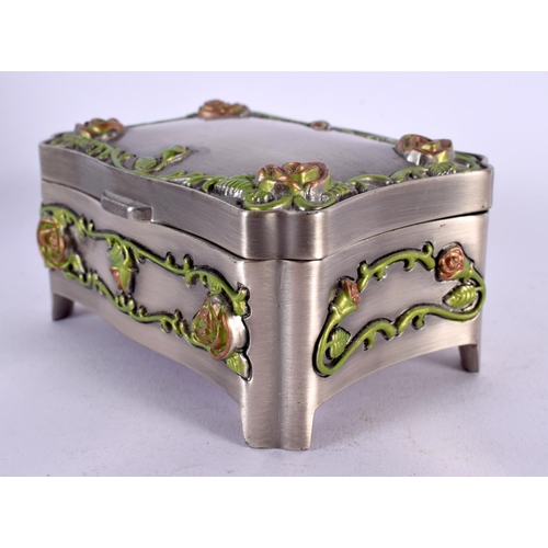 465 - AN UNUSUAL ENAMELLED WHITE METAL JEWELLERY BOX overlaid with foliage and vines. 381 grams. 10 cm x 7... 