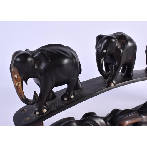 489 - A LATE 19TH CENTURY ANGLO INDIAN CARVED HARDWOOD ELEPHANT GROUP modelled roaming. 45 cm x 20 cm.