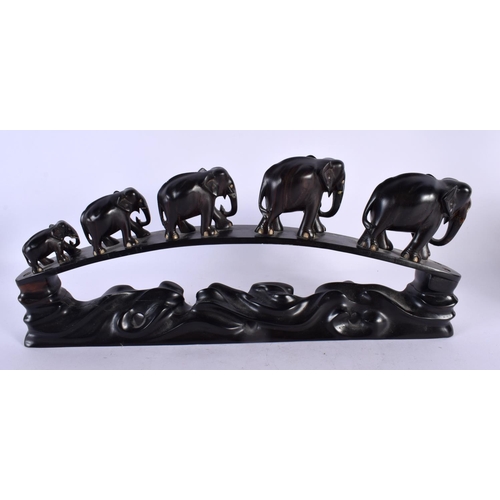 489 - A LATE 19TH CENTURY ANGLO INDIAN CARVED HARDWOOD ELEPHANT GROUP modelled roaming. 45 cm x 20 cm.