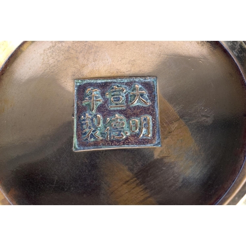 492 - AN 19TH CENTURY CHINESE TWIN HANDLED BRONZE CENSER bearing Xuande marks to base. 389 grams. 13 cm wi... 