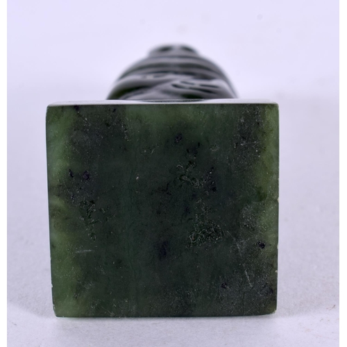 501 - A NEW ZEALAND TRIBAL CARVED JADE MAORI IDOL upon a square form base. 8 cm x 2 cm.