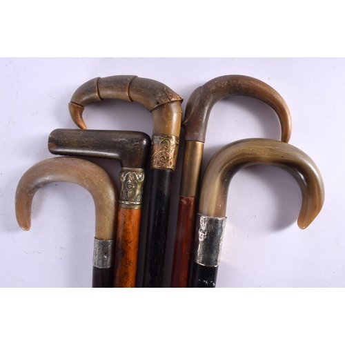 513 - A GROUP OF FIVE 19TH CENTURY MIDDLE EASTERN CARVED RHINOCEROS HORN CANES two with silver mounts. 90 ... 