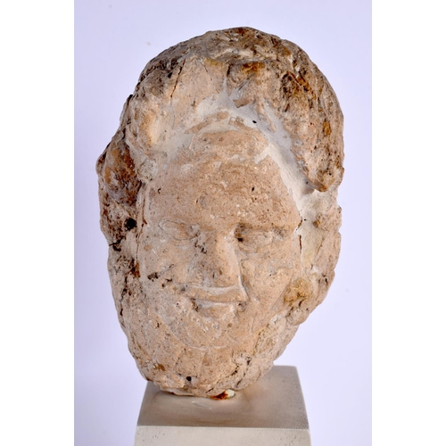 535 - A RARE ROMANO BRITISH CARVED LIMESTONE HEAD C200AD depicting an elderly male, upon a white painted w... 