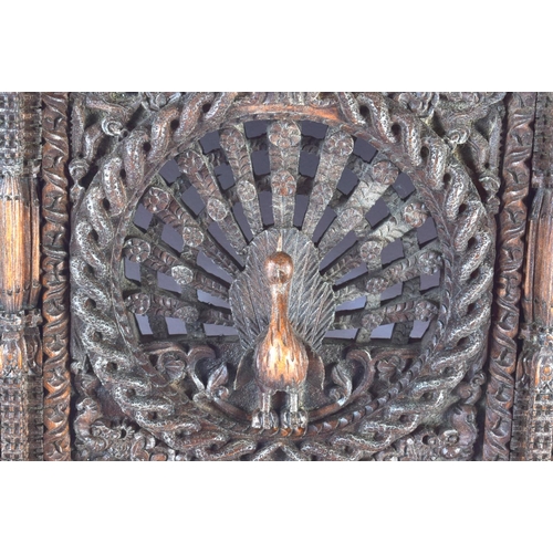 543 - A 19TH CENTURY BURMESE JAVANESE CARVED WOOD TEMPLE PANEL together with a similar Nepalese carved woo... 